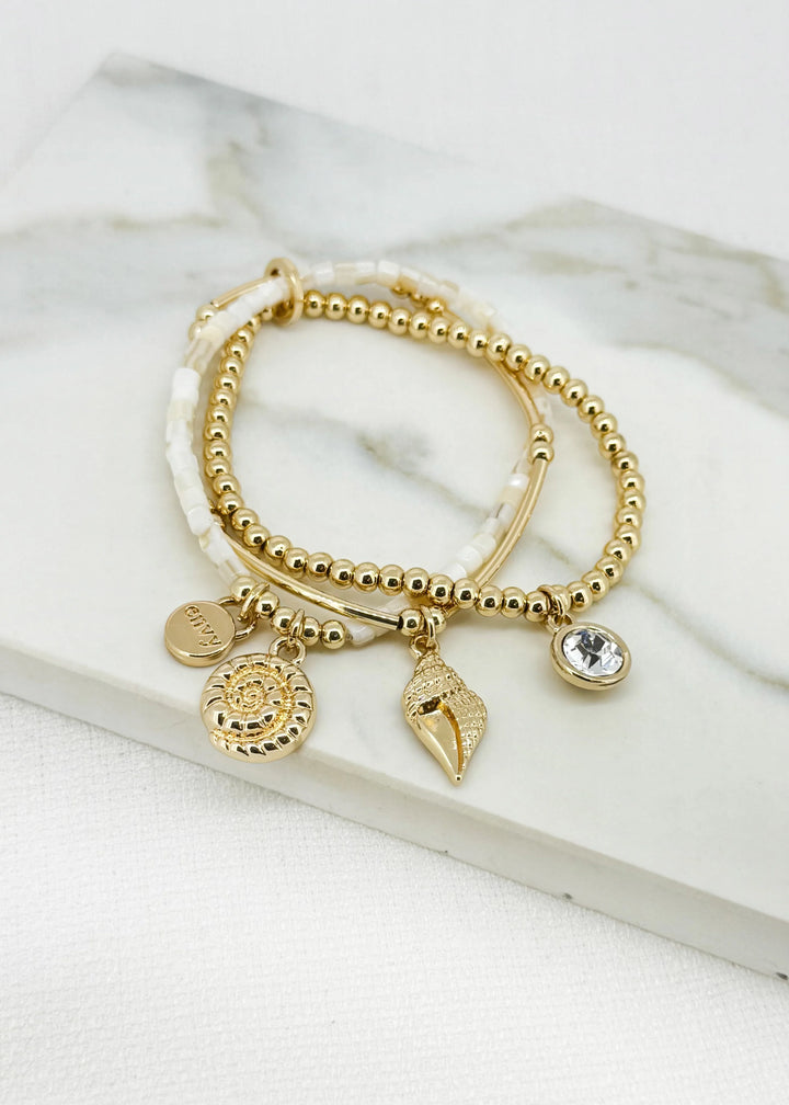 Gold triple layered stretch bracelet with fossil charm